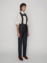 Tailored overalls with oval shape straps and cuff details on the hem