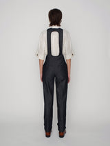 Tailored overalls with oval shape straps and cuff details on the hem